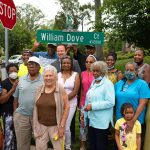 family of william dove around street sign